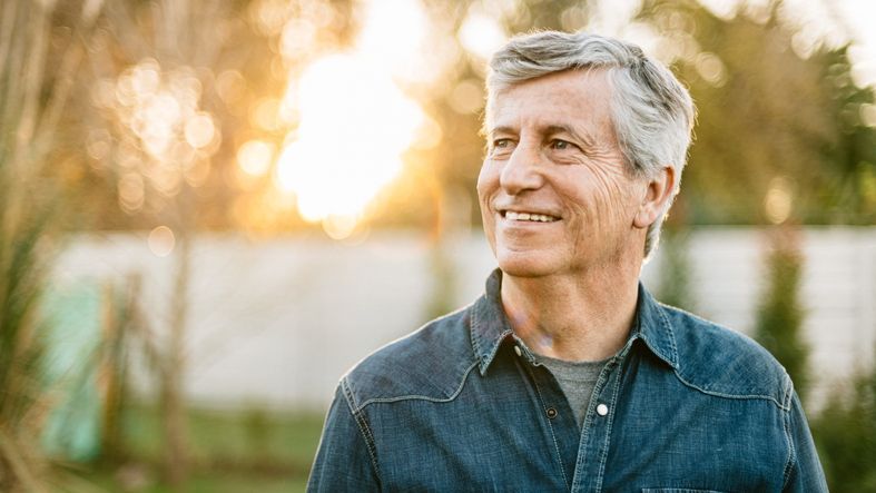 A portrait of a male retiree taken at sunset.